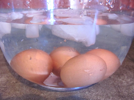 cool hard boiled eggs in ice water