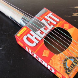 Make a toy guitar out of recycled materials