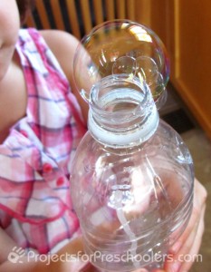 blowing bubbles with a plastic bottle