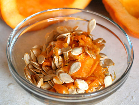 Scoop the pumpkin seeds out of the pumpkin