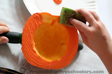 Apply paint to pumpkin stamp