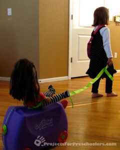 Pulling dolls on the Trunki